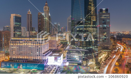 Dubai International Financial district aerial day to night timelapse. Panoramic view of business and financial office towers. 106860920