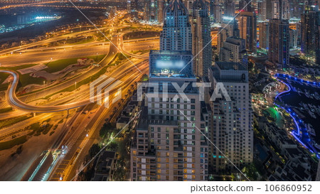 Dubai marina and JLT skyscrapers along Sheikh Zayed Road aerial all night timelapse. 106860952