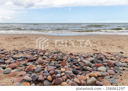 Seaside landscape with shore water and colorful pebble 106861297
