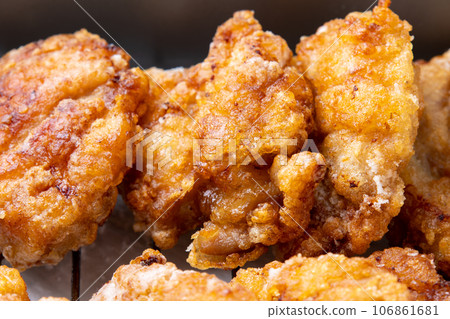 Freshly fried chicken thighs on a frying pan. 106861681