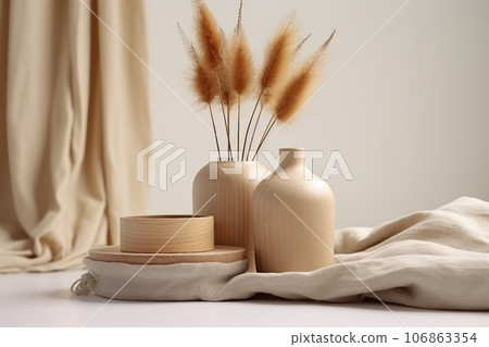 Rabbit tail grass in beautiful tan vase, wooden storage box, neutral beige blanket against white wall. Aesthetic minimal hygge interior design concept Rabbit tail grass in beautiful tan vase, wooden storage box, neutral beige blanket against white wall. Aesthetic minimal hygge interior design concept 106863354
