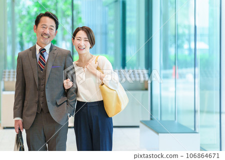 Portrait of a couple walking arm in arm 106864671