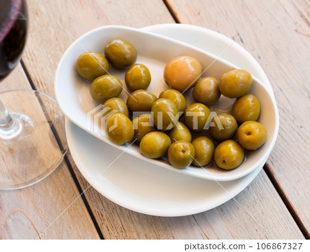 Green olives on plate 106867327