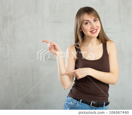 Smiling young woman gesturing in studio 106867490