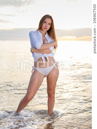Portrait of sensual young lady enjoying warm, tropical ocean water 106867500