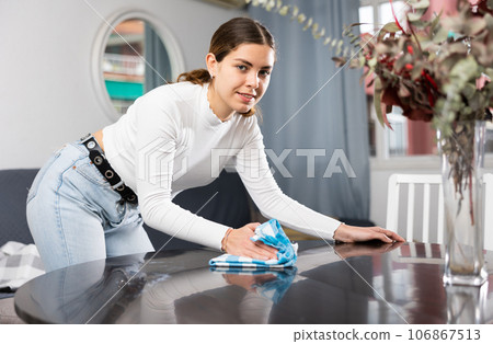 Woman householder using rag to wash table Woman householder using rag to wash table 106867513