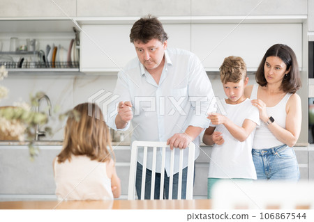 Parents scold their daughter in kitchen at home 106867544