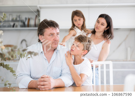 Family with two children in kitchen during quarrel Family with two children in kitchen during quarrel 106867590