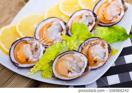 Fresh bivalve mussels with lemon Fresh bivalve mussels with lemon 106868242