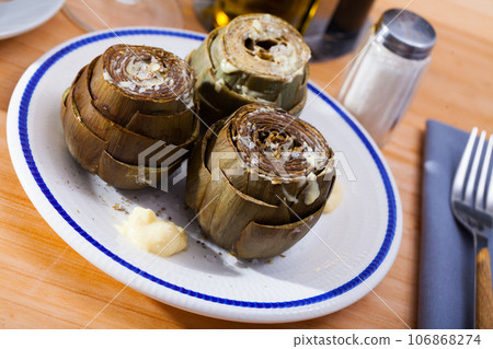 Plate of tasty steamed artichoke 106868274