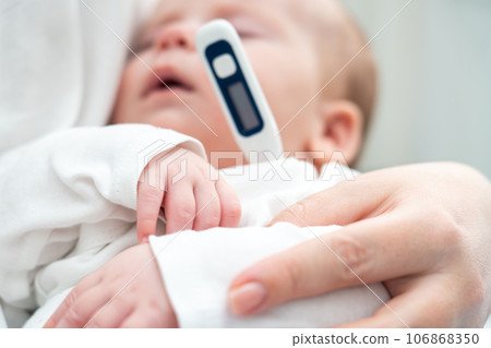 Restful baby gets temperature measured electronically, Concept of early signs of fever Restful baby gets temperature measured electronically, Concept of early signs of fever 106868350