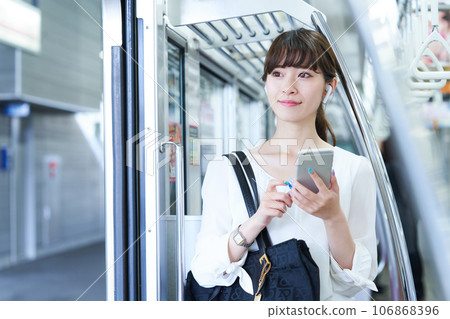 Young woman riding a train. Photography provided by Keio Electric Railway Co., Ltd. Young woman riding a train. Photography provided by Keio Electric Railway Co., Ltd. 106868396