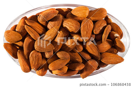 Image of roasted salt almonds on glass bowl, nobody 106868438