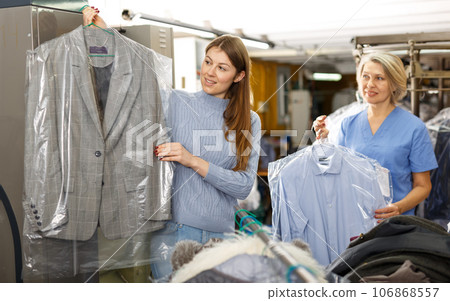 Client receiving her clean clothes Client receiving her clean clothes 106868557
