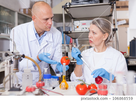 Biochemists checking fruits and vegetables Biochemists checking fruits and vegetables 106868559