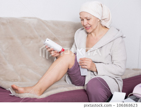 Woman doing body hair removal Woman doing body hair removal 106868623