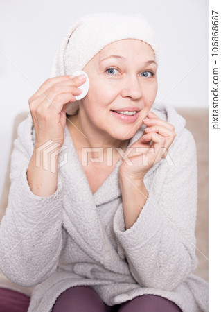 Woman cleaning face Woman cleaning face 106868687