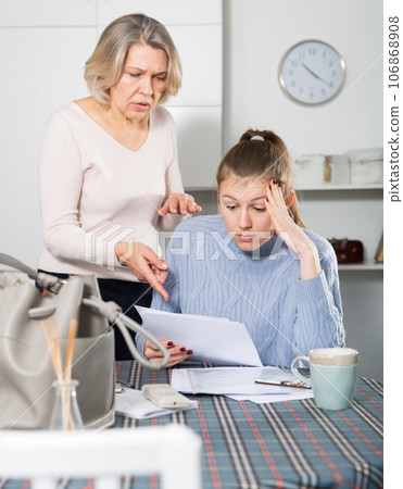 Unhappy woman with documents, family quarrel Unhappy woman with documents, family quarrel 106868908