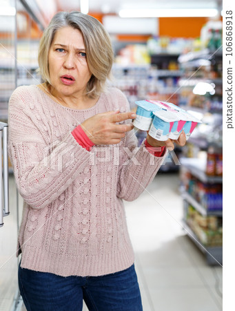 Shocked woman shopping in grocery Shocked woman shopping in grocery 106868918
