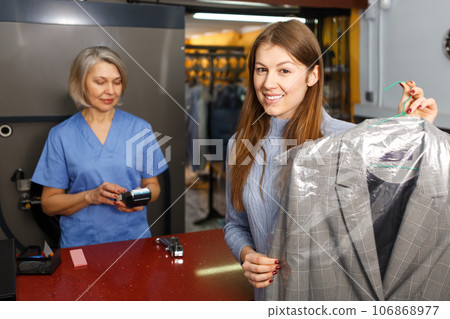 Portrait of satisfied adult female customer 106868977