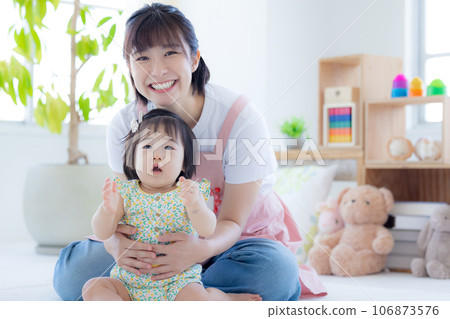 Portrait of baby and childcare worker 106873576