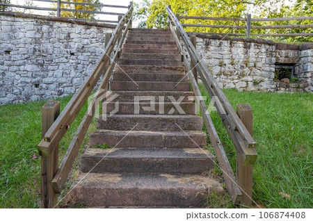 Low angle view up outdoor stone staircase in colonial American village 106874408