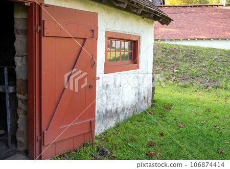 Colonail American stone cottage with red door Colonail American stone cottage with red door 106874414