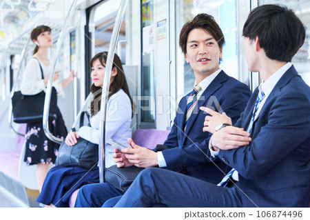 A man talking on a train. Photography provided by Keio Electric Railway Co., Ltd. A man talking on a train. Photography provided by Keio Electric Railway Co., Ltd. 106874496