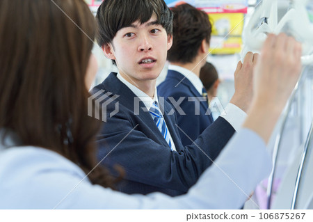 A man talking on a train. Photography provided by Keio Electric Railway Co., Ltd. A man talking on a train. Photography provided by Keio Electric Railway Co., Ltd. 106875267