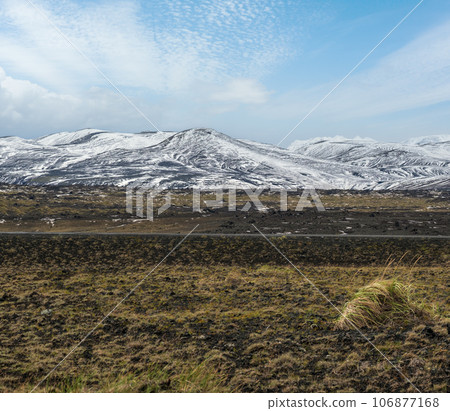 Colorful Landmannalaugar mountains under snow cover in autumn, Iceland. Lava fields of volcanic sand in the foreground. Colorful Landmannalaugar mountains under snow cover in autumn, Iceland. Lava fields of volcanic sand in the foreground. 106877168