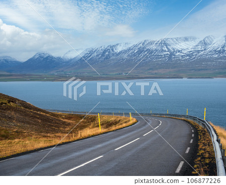 Highway road and mountain view during auto trip in Iceland. Spectacular Icelandic landscape with scenic nature Highway road and mountain view during auto trip in Iceland. Spectacular Icelandic landscape with scenic nature 106877226