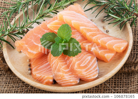 salmon with rosemary on wood background salmon with rosemary on wood background 106878165
