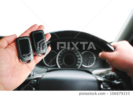 Driver hand holding a car keyless entry remote for engine start or stop. copy space Driver hand holding a car keyless entry remote for engine start or stop. copy space 106879153