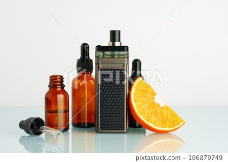 Vape liquid with orange flavor on white background Vape liquid with orange flavor on white background 106879749