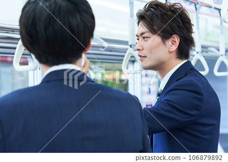 A man talking on a train. Photography provided by Keio Electric Railway Co., Ltd. A man talking on a train. Photography provided by Keio Electric Railway Co., Ltd. 106879892