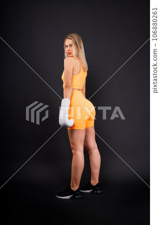 Female boxer hitting at a boxing studio. Woman in gloves training hard. Female boxer hitting at a boxing studio. Woman in gloves training hard. 106880261