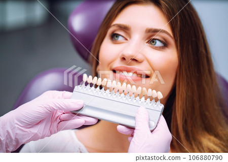 Beautiful woman smile with healthy teeth whitening. Matching shades of the implants. Healthy Smile. 106880790