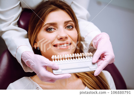 Beautiful woman smile with healthy teeth whitening. Matching shades of the implants. Healthy Smile. 106880791