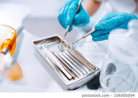 A set of sterile dental instruments for dental treatment. Dental care for people. 106880894