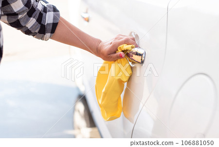 Girl polishing car door handle Girl polishing car door handle 106881050