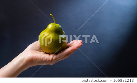 Hand holding pear Hand holding pear 106881218