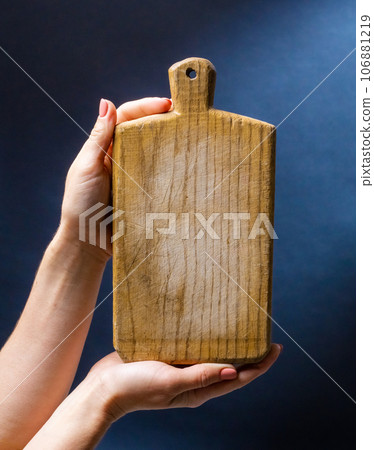 Hand holding kitchen board Hand holding kitchen board 106881219
