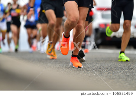 City marathon: the feet of a marathon runner running up a slope City marathon: the feet of a marathon runner running up a slope 106881499