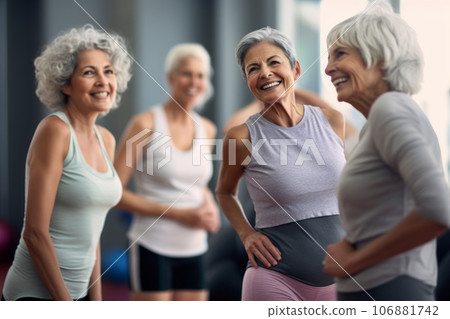 A group of happy elderly women in light sports T-shirts stands in the lobby of the gym A group of happy elderly women in light sports T-shirts stands in the lobby of the gym 106881742