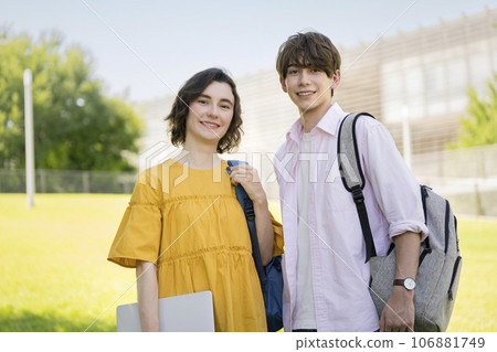 Global image of male and female university students smiling at the camera Global image of male and female university students smiling at the camera 106881749