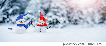 Little snowmen on the white snow on blue background. 106881753