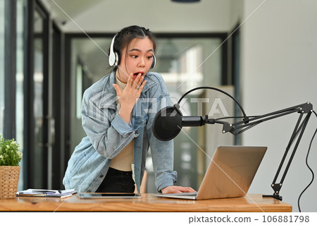 Surprised woman radio host interacting with audience, receiving shocking answers during online live broadcast session Surprised woman radio host interacting with audience, receiving shocking answers during online live broadcast session 106881798