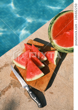 sliced watermelon is lying by the pool sliced watermelon is lying by the pool 106882250