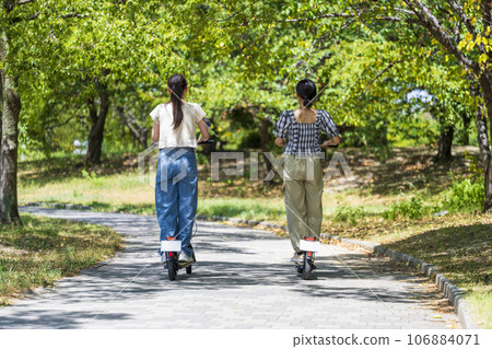 Young woman traveling on electric scooter 106884071