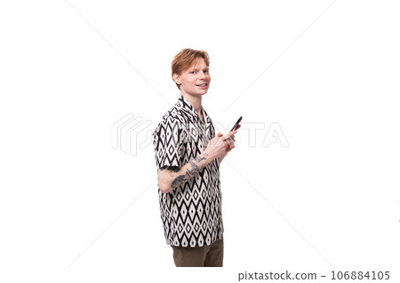 portrait of a slender young man with golden copper hair and a tattoo on his arms dressed in a black portrait of a slender young man with golden copper hair and a tattoo on his arms dressed in a black 106884105